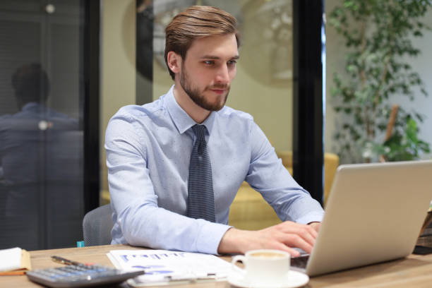 istock Young modern business man working using laptop while sitting in the office. 1226762746
