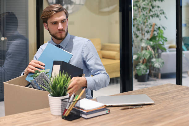 istock Sad dismissed worker are taking his office supplies with him from office. 1226763213