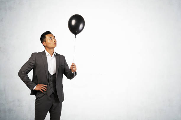 istock Asian businessman holding balloon, mock up 1226763259