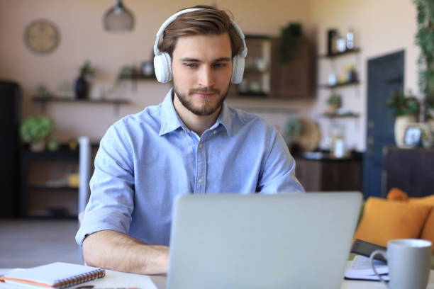 istock Confident man wearing headset speaking and watching business webinar training, listening to lecture. 1226763521