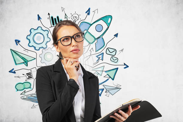 istock Thoughtful woman in glasses, startup sketch 1226764214