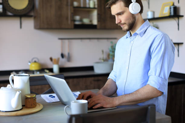 istock Concentrated young freelancer businessman using laptop for video conferance, working remotely online at home. 1226764273