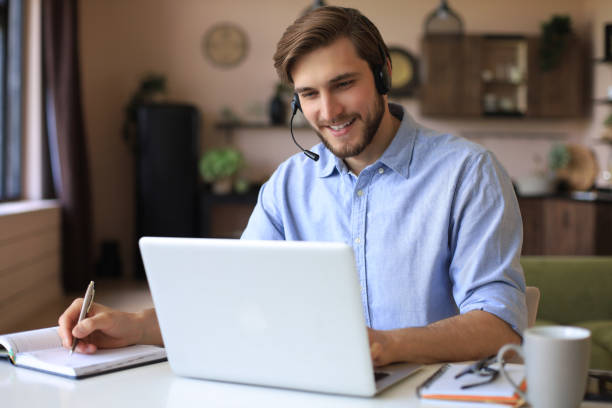 istock Confident man wearing headset speaking and watching business webinar training, listening to lecture. 1226764557