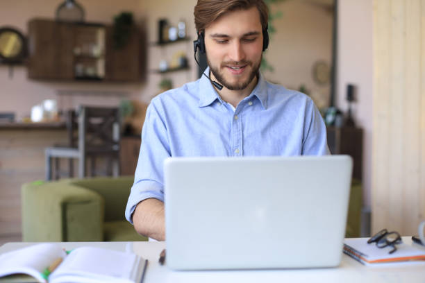 istock Confident man wearing headset speaking and watching business webinar training, listening to lecture. 1226764605