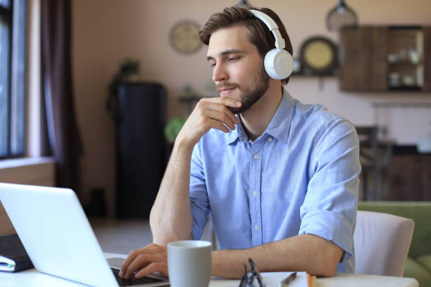 istock Confident man wearing headset speaking and watching business webinar training, listening to lecture. 1226764873
