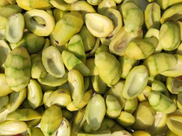 istock the unripened mango, seeds removed ,cut into two pieces,  wooden table. 1226764903