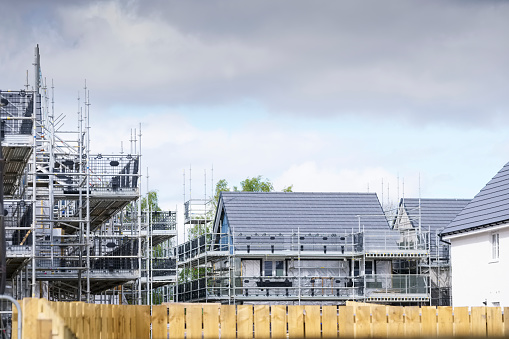 Building affordable homes with scaffolding safety by local construction council to help government social housing problem and shortage England UK