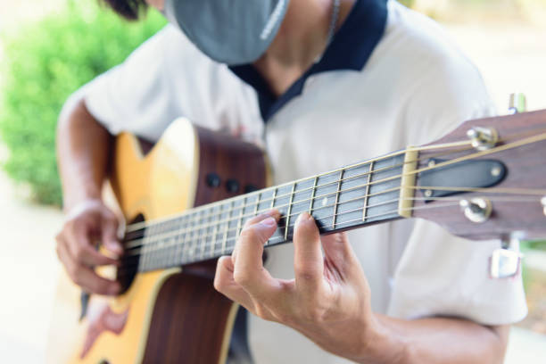 istock playing guitar in the park 1226765689
