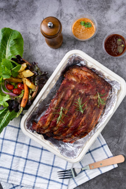 istock Grilled pork ribs with Vegetables and sauces on a drak table. 1226766321