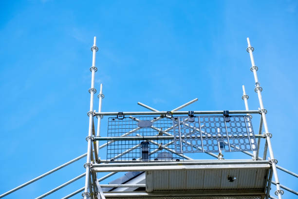 Scaffold platform and poles close up in blue sky at construction building site