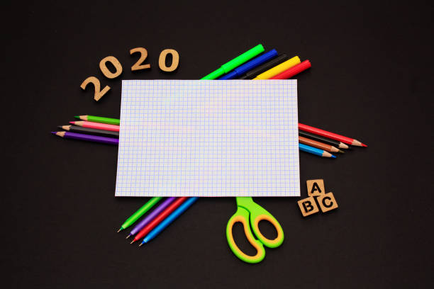 School accessories on black paper background