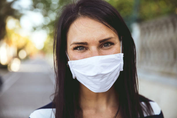 istock Woman smiling behind the protective mask 1226767682