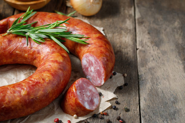 istock Smoked sausage on a wooden table. 1226769401