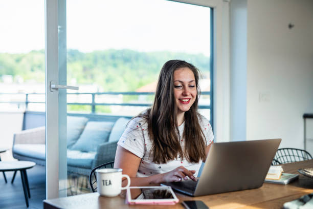 istock Lovely Caucasian Working From Home and Using Laptop 1226770481