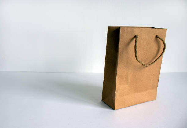 Disposable bag of kraft paper on a beautiful white background, copy space.