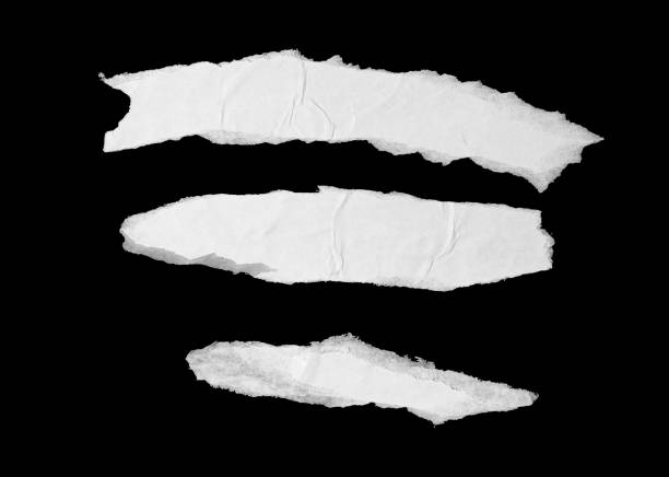 Ripped glued white paper pieces isolated on black background Torn creased glued paper texture. Ripped wrinkled white paper poster pieces isolated on black background wild posting ad stock pictures, royalty-free photos & images