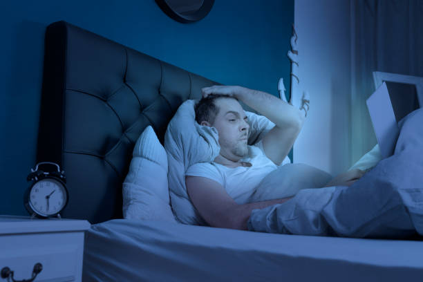 istock overtired man works on his laptop at late night 1226774849