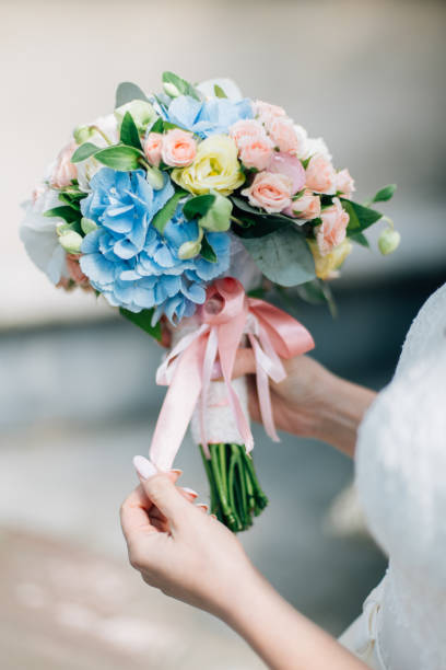 istock Wedding bouquet of flowers held by bride closeup. 1226775184