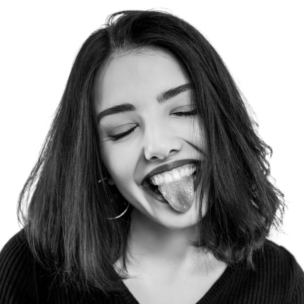 Black and white young woman showing tongue stock photo