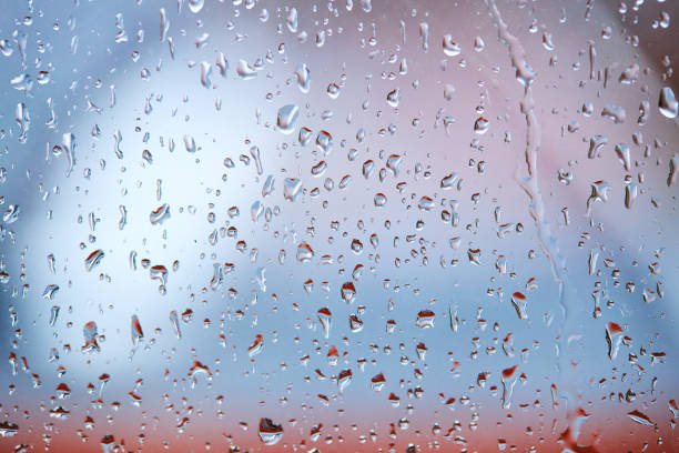 istock rain droplets on glass over calm colorful background. business backdrop 1226777490