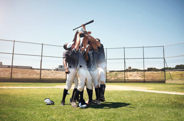 See what happens when you play as a team? Shot of a group of young baseball players celebrating after winning a game baseball player photos stock pictures, royalty-free photos & images