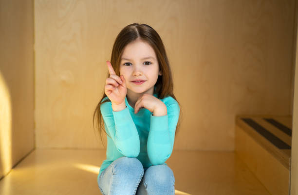 istock Cute joyful child sitting on steps at home 1226780404