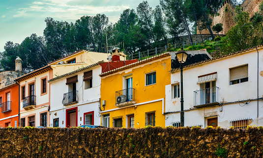 View of colorful homes in the picturesque town of Denia, located on the Mediterranean coast of Spain.