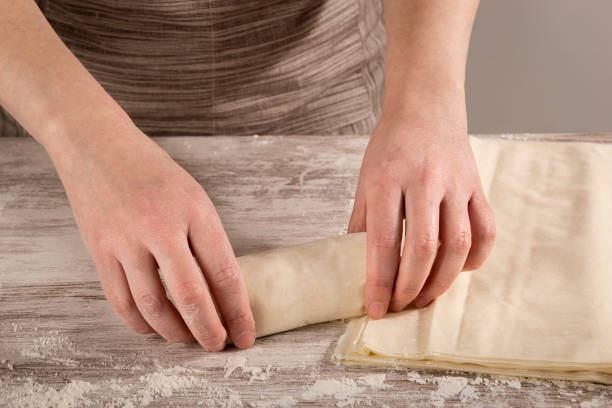 istock Woman making tuna rolls with phyllo dough for baking 1226784911
