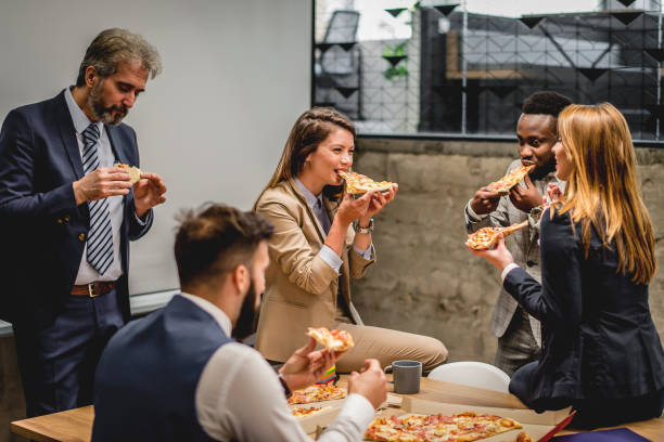 istock Business people talking and having pizza on lunch break at office 1226786823