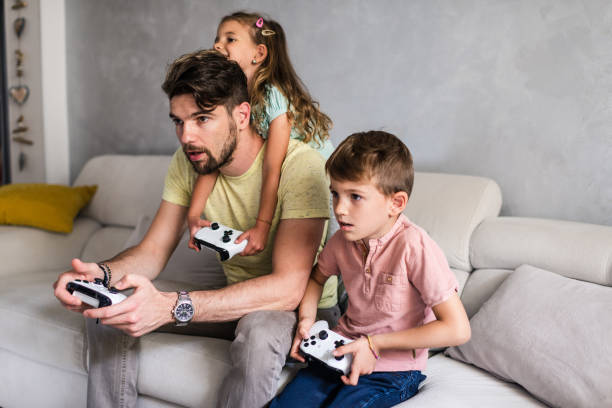 istock Playing video games with our dad 1226789207