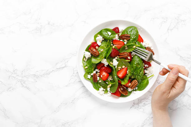istock Fresh spinach salad with strawberry, pine and pecan nuts, goat cheese, maple syrup dressing 1226790758