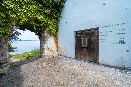 Traunkirchen, Austria - May 22nd 2020: 1594, 1887, 1897, 1899 and 1920. These were the years of the worst floodings of the Traunsee. They were recorded with markings at the rear of the Traunkirchen monastery.