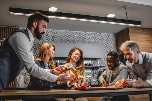istock Business people having pizza on break at kitchen near office 1226792158