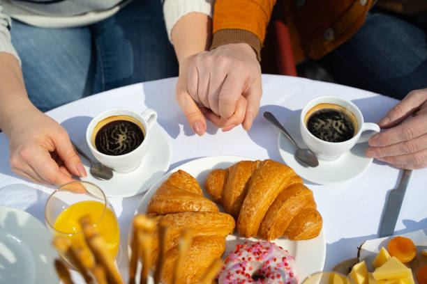 istock Married couple holding hands while having breakfast outdoors 1226793392