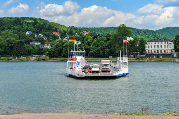 Linz am Rhein, Germany - June 12, 2009:  A car and passenger ferry crossing  the River Rhine is about to arrive at the pier. The ferry connects Remagen in Rheinland-Pfalz on the western bank with Linz am Rhein on the eastern bank of River Rhine.
