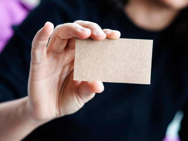 istock Woman holding blank visitcard,showing visit card 1226797615