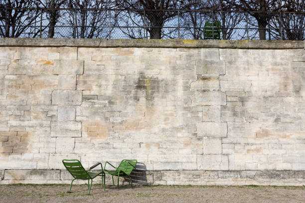 Two traditional green chairs with no people in the Tuileries Garden, Paris, France