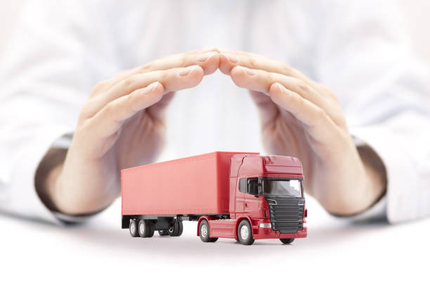 istock Red long truck with a trailer protected by hands 1226798546
