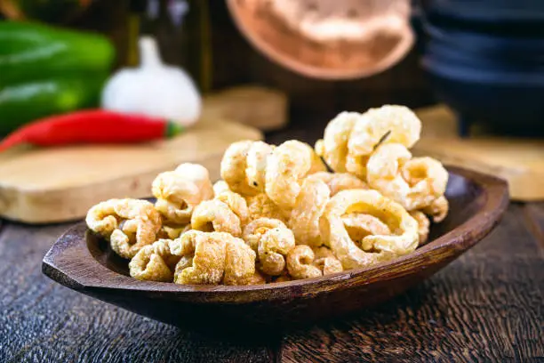 Photo of crackling the Brazilian pururuca. Pork skin fried and served dry, with accompaniment. Brazillian tipical food.