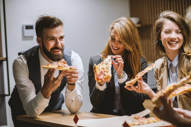 istock Business people having pizza on break at kitchen near office 1226800262