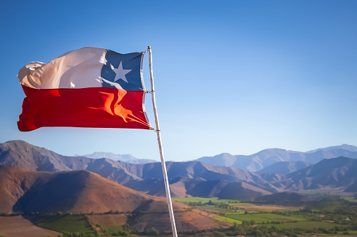 Chilean flag with mountains on the background
