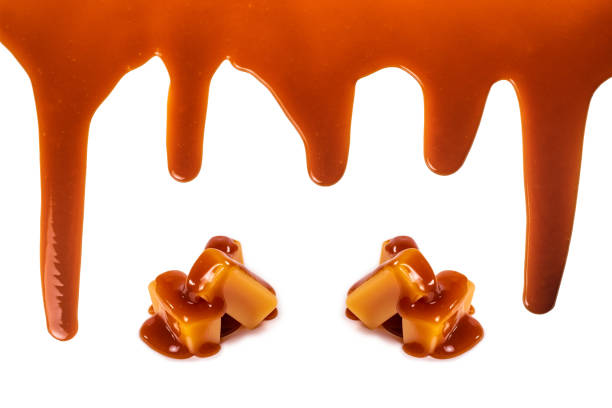 istock Background of flowing caramel sauce isolated on white. 1226803111