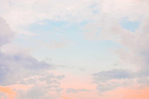 Warm summer or spring light neon-colored sunset or sunrise sky with moon.