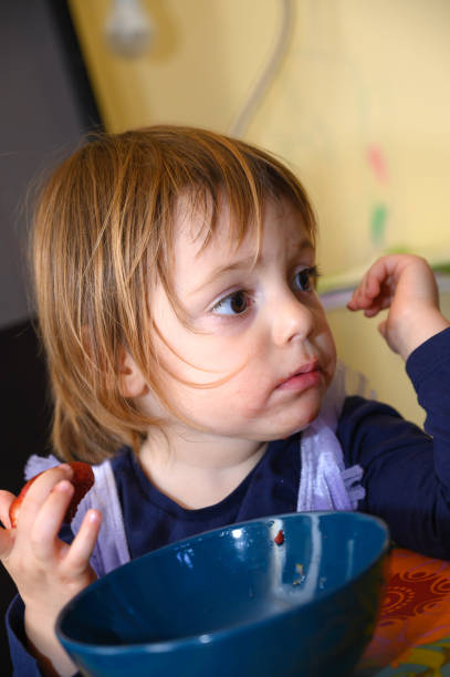 istock Girl eating strawberries 1226805734