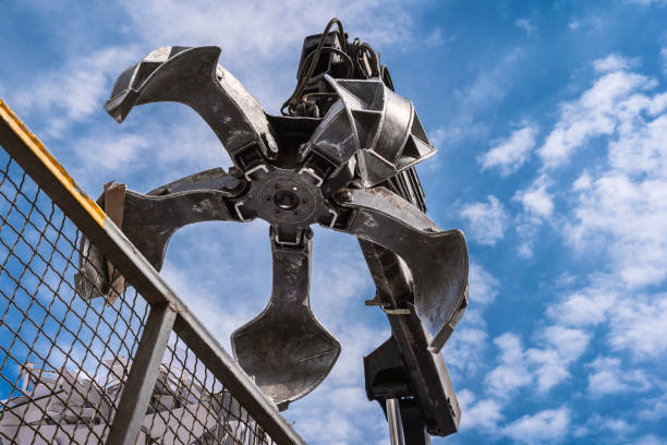 istock Big crane dropped scrap on pile. Industrial grabber. 1226805797