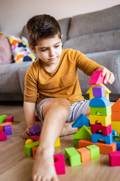 istock Funny boy playing with blocks at home 1226806785