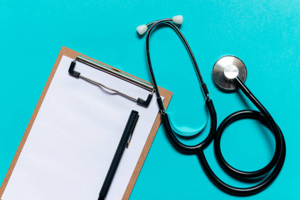 istock Stethoscope and notepad on blue background. Heart check or health check concept 1226808499