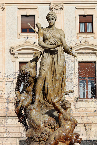Fountain of Diana, goddess of Hunt, located in Archimede Square in Ortygia Island featuring sculptures telling the story of Arethusa's metamorphosis