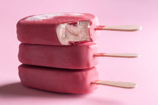 Ice cream popsicles with pink chocolate glaze. Vanilla ice cream