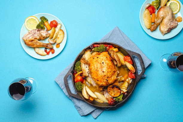 istock Roasted chicken and wine glasses, dinner table top view 1226810971